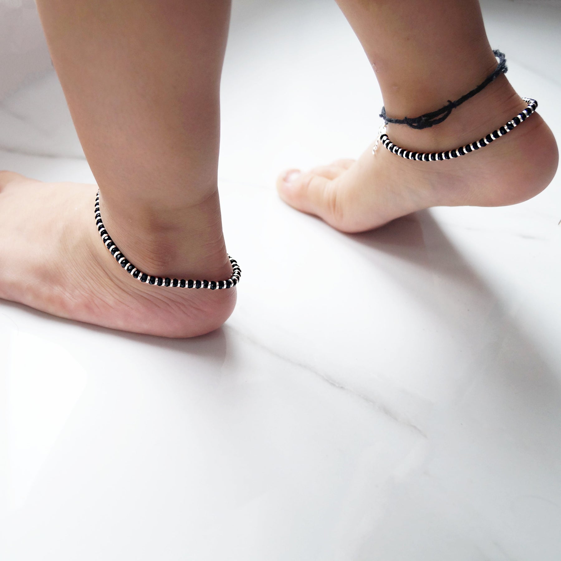 Image of Closeup Shot Of Indian Girl Child Ankle Bracelet Isolated On Bare  Feet-PL834132-Picxy